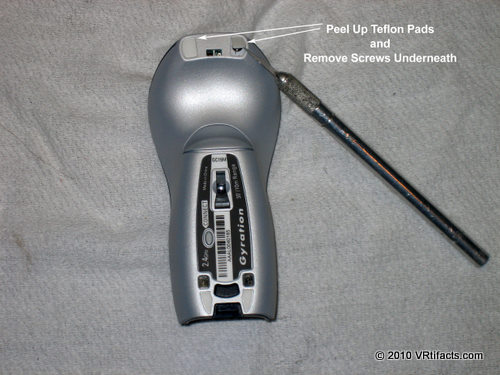 Then peel up the 2 teflon pads on the bottom front of the mouse and remove the 2 screws under the pads.